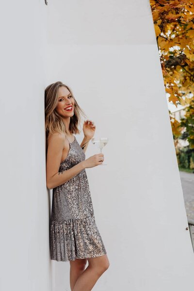 kaboompics_blond-woman-in-a-sequin-dress-is-holding-a-glass-of-champagne-14687-optimized