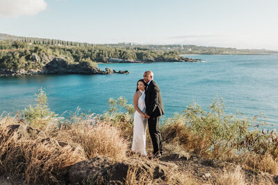 bride and groom smiling into the distance