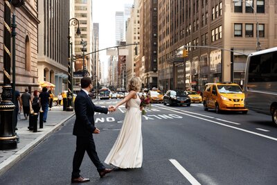 bride-holds-groom-s-hand-walking-across-street-new-york-min