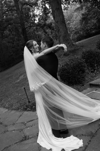 Close up view of delicate wedding dress skirt, wedding bouquet, and heels