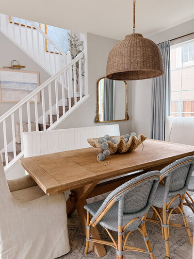 a dining room with a wood table and gray chairs