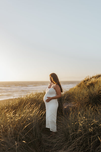 woman in field for maternity photos
