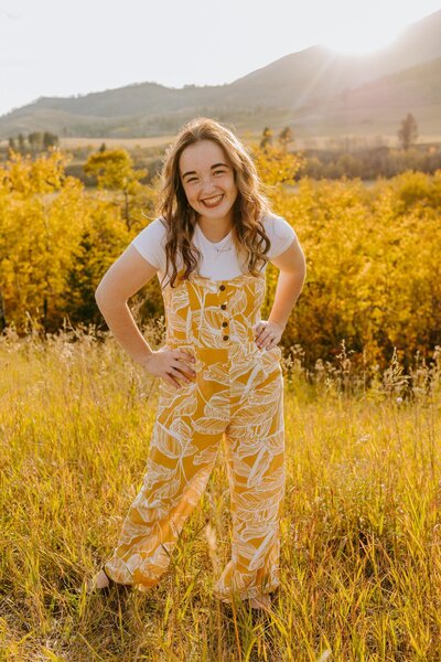 Makena poses for a fall shoot with bright yellow colors in nature.
