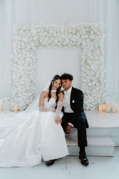 classic wedding couple sitting on the steps of the ceremony stage at Cold Springs wedding venue in Little Rock, Arkansas