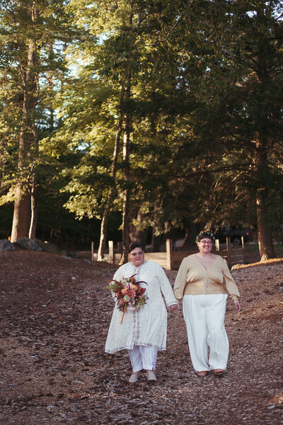 Couple walking together hand in hand in woods