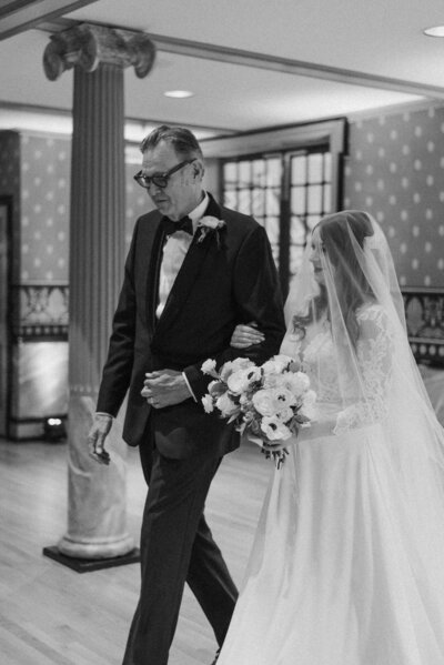 Bride and father walking down isle at wedding ceremony in Richmond, VA.