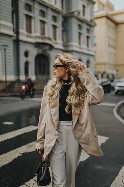 Confident woman in white jacket