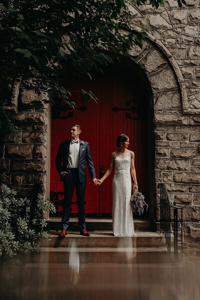 Couple in front of the red door of a  the church they just got married in Atlanta www.tintedevents.com
