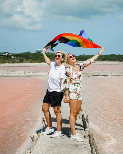 It's Chris and Alex holding gay rainbow flag