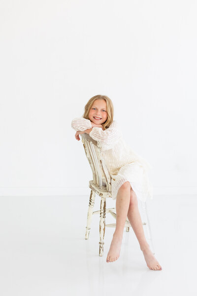 child sitting in a chair at Tiffany Hix Photography