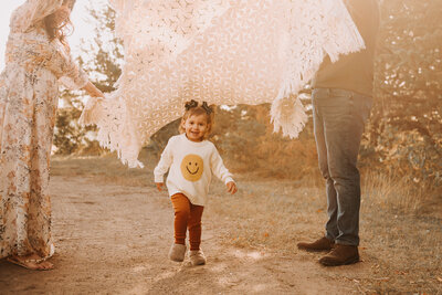 Running around and giggling is top of the list of things to do for this little one during their Sweet Briar Lake fall mini.