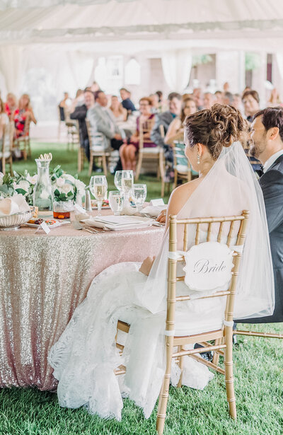 Bride and groom sitting at sweetheart table