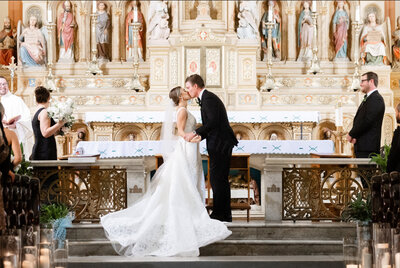 bride and groom kissing at church wedding in New Orleans