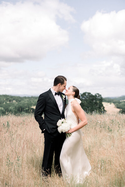 Black & White image of couple entering their wedding reception
