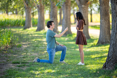 a man on his knee proposing to a women in Erie, Colorado