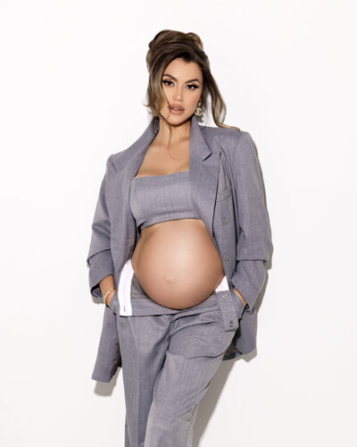 Pregnancy photoshoot in grey suit in Vancouver photo studio by Liliya Lubenkova Portraits. 