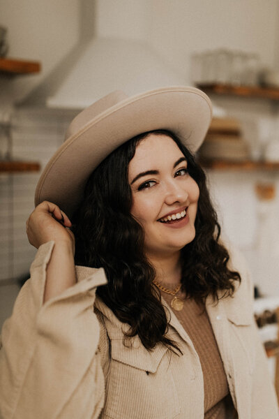 Kris, founder of Femme Collective, smiling at the camera