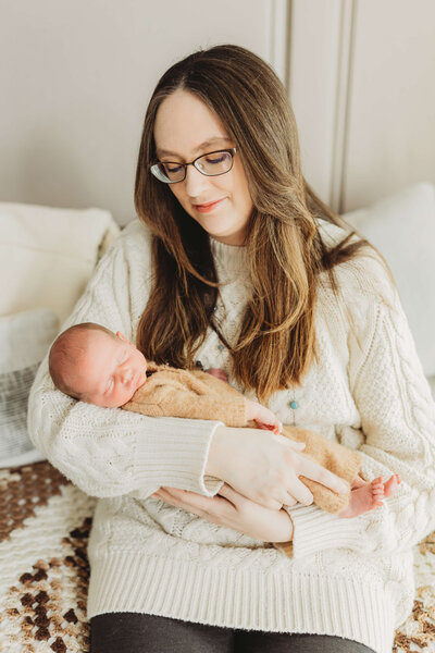 parents with their foreheads together holding their newborn baby boy 