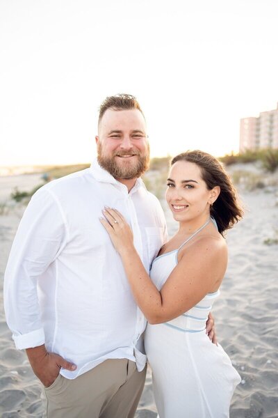 Couple smiling and posing on the beach for destination wedding travel agent CC vacations
