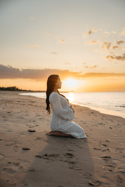 Mom sitting on the beach at sunset. Maternity photographers nj, New Jersey Family photographers