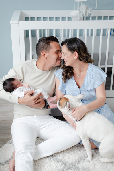 mom dad newborn and frenchie puppy in nursery all blue animal theme by miami maternity photographer msp photography David and Meivys Suarez