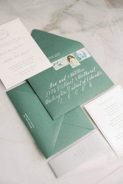 Green wedding stationery with calligraphy