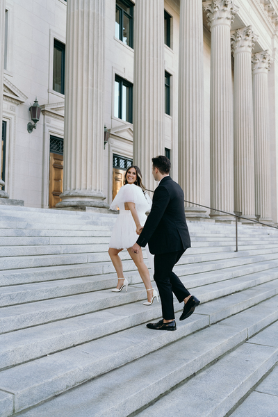 Bride and groom on the stairs of a courthouse celebrating their wedding | Megan Smith Photography