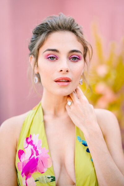 woman with pink eyeshadow and green floral gown