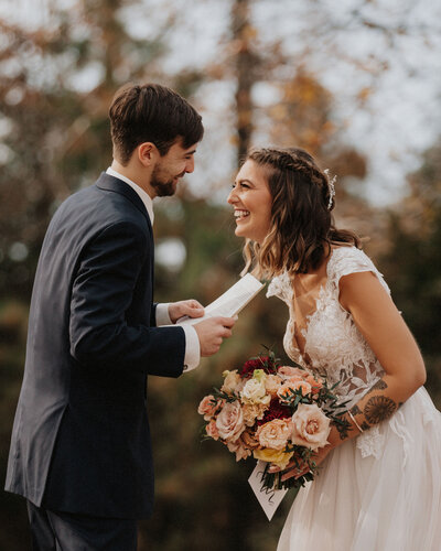 wedding couple stands near a lake