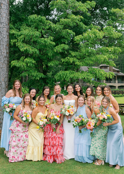 Girls in dresses outside holding bouquets