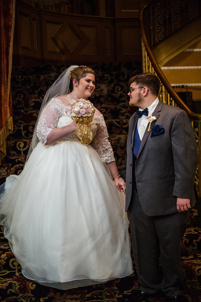 Bride and groom have first look on grand staircase at Warner Theatre