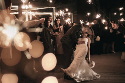 The newly weds share a kiss during their sparkler exit.