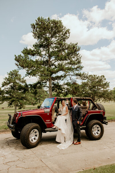 a couple getting into a jeep after their wedding