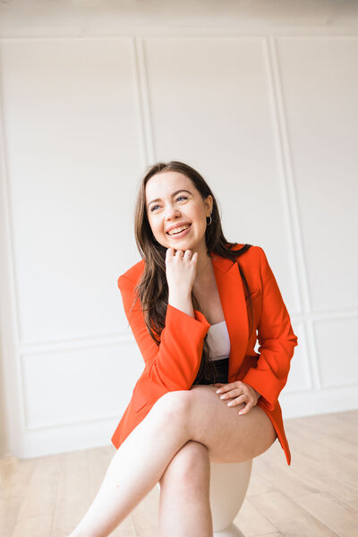 woman sitting on a stool and smiling