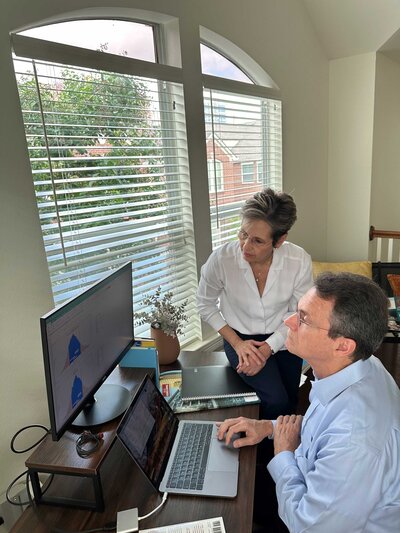Dallas financial consultants for small businesses working diligently in their office. They are utilizing a desktop computer and laptop to provide expert financial advice and services.
