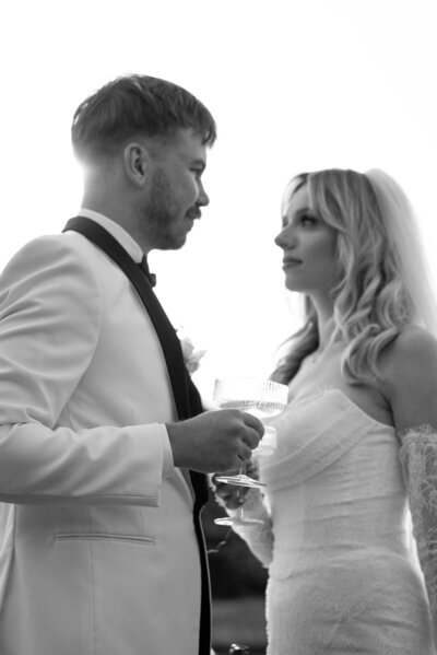 Editorial styled photo of bride and groom looking at each other at Cascade ponds.