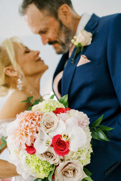 Bride and Groom in background with bouquet