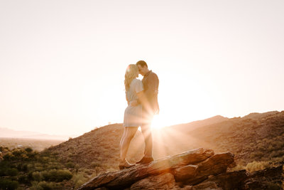 Sunset engagement pictures in a the desert on a hill