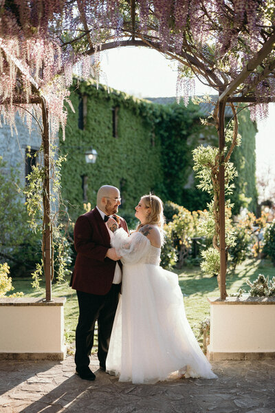 Italy wedding day bliss: couple in Tuscany, captured in a moment of pure joy.