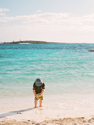 Young boy playing in water in the Bahamas.