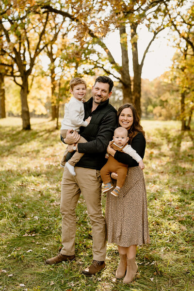 parents hold newborn on couch