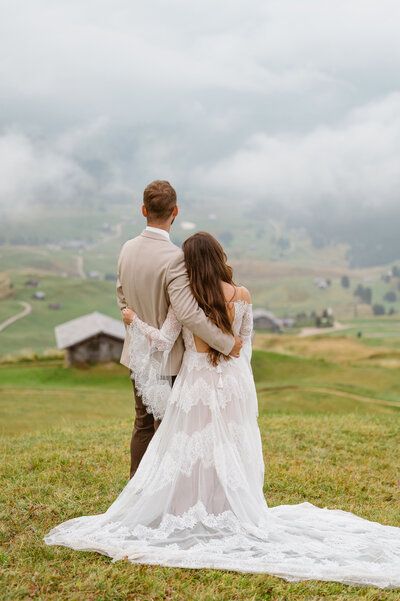 Elopement couple holds hands while facing each other and reading vows