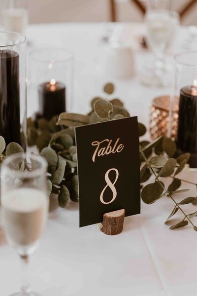 Table setup at wedding with black candles.