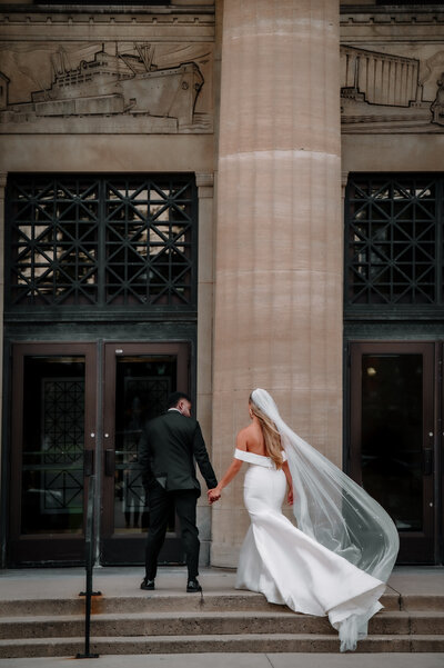 bride groom walking up stairs entering the Liuna Station wedding venue
