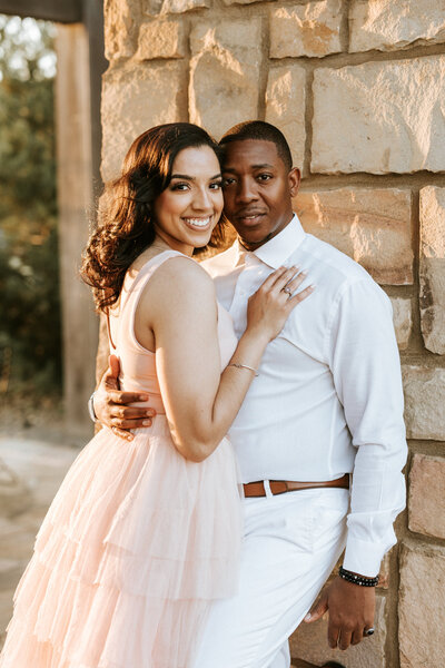 bridal make up artist whitney elise places powder on bride sitting in chair