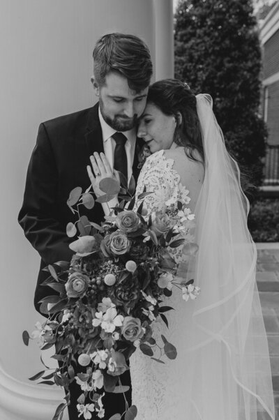 bride resting her head on groom's shoulder