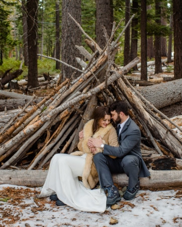 Lake Tahoe Wedding Planners couple sitting under tepee in snow with fur coat at venue The Resort at Squaw Creek, Lake Tahoe, Joy of Life Events image by Charleston Churchill