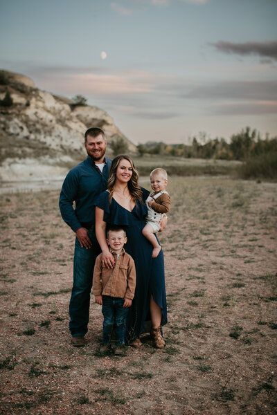 Family photo session in Medora, ND, at Theodore Roosevelt National Park, featuring a family enjoying quality time together amidst the dramatic landscapes of the Badlands. Perfect for families seeking a unique and scenic backdrop.