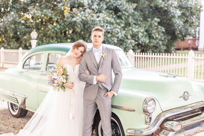 Couple posing by their car at a North Carolina Christian wedding
