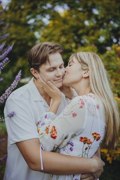 woman kissing her fiance on the chek